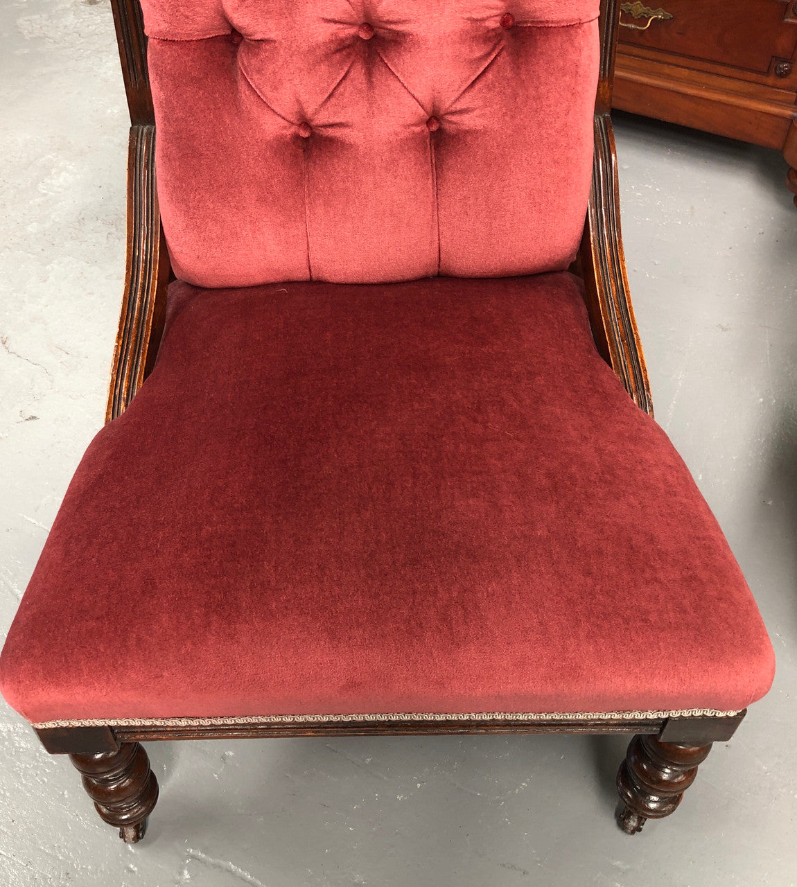 Beautiful pair of carved Edwardian arm chairs with lovely pink upholstery with button backs. In good condition.