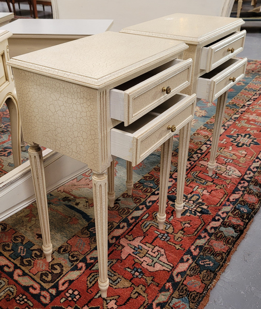 Pair of Vintage Louis 16th style painted crackle finish two drawer French style bedsides. They have elegant reeded legs and have been sourced from France. They are in good original condition.