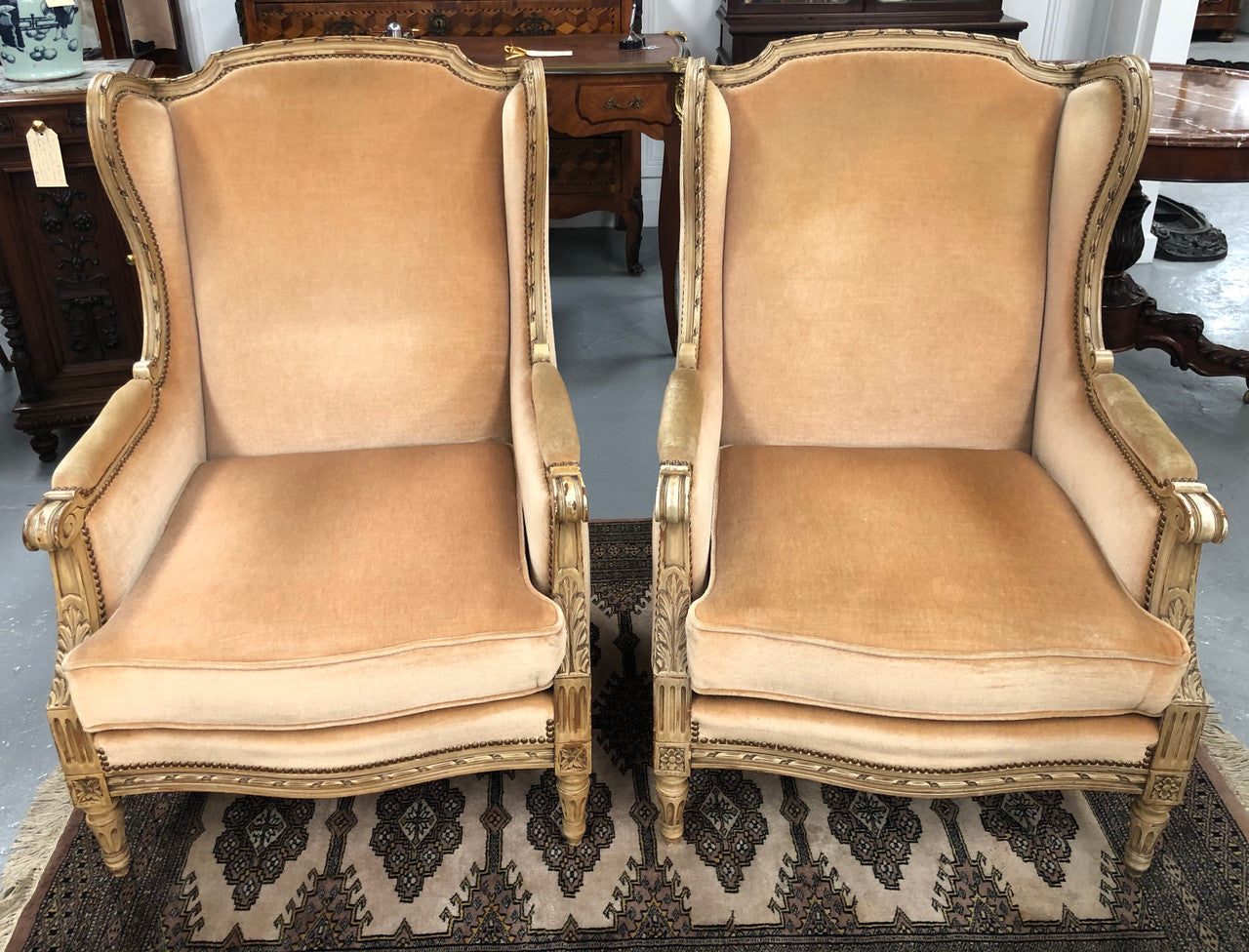 Pair of Vintage French original painted bergere wingback armchairs. The fabric is in very good original condition, please view photos as they help form part of the description. Please note the matching foot stool is being sold separately.