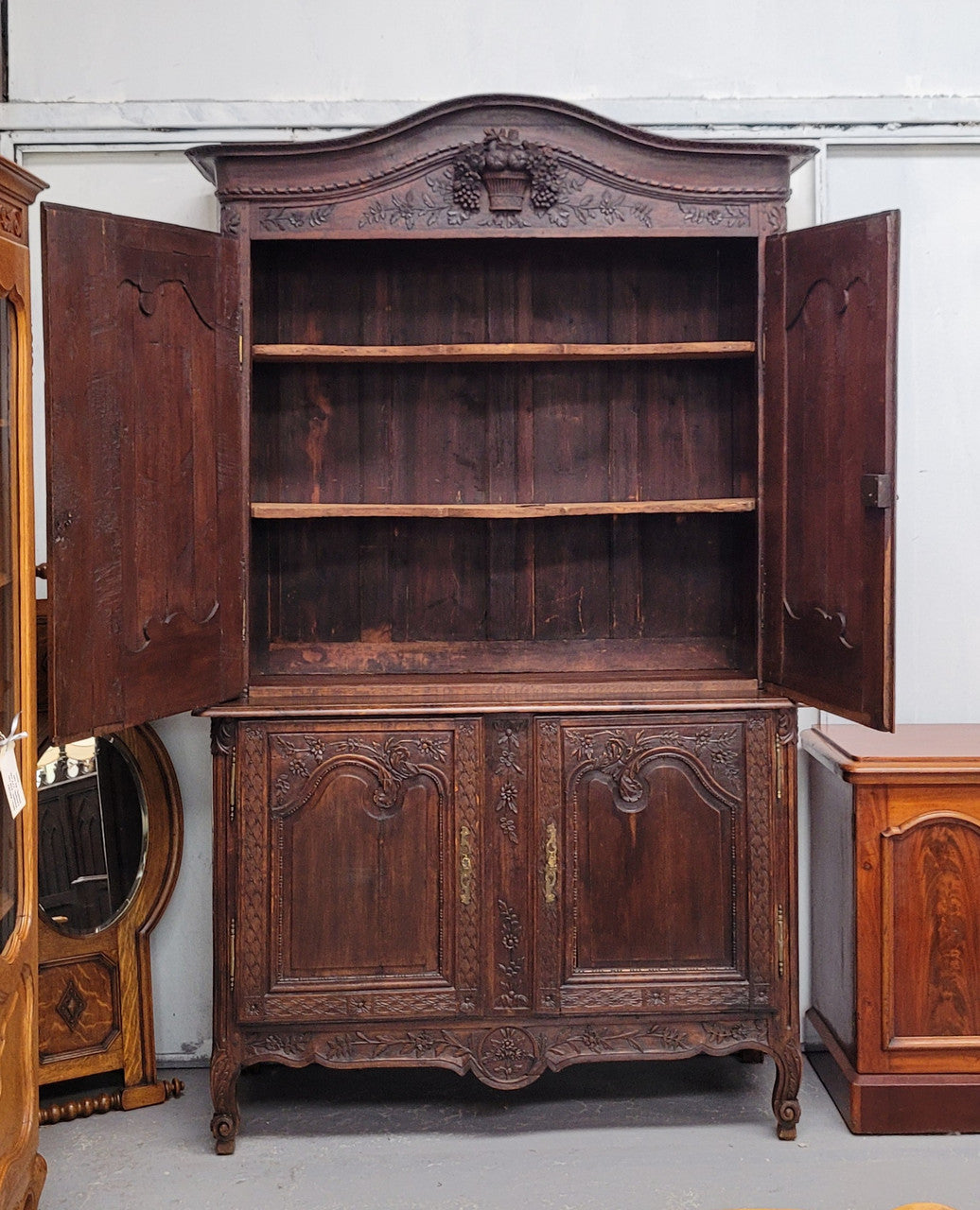 French Oak 18th Century superbly carved sideboard buffet. This amazing buffet has loads of character which is expected being circa 1790's. The top section has two fixed shelves and the bottom section has one fixed shelf. It has been sourced from France and is in good original detailed condition.