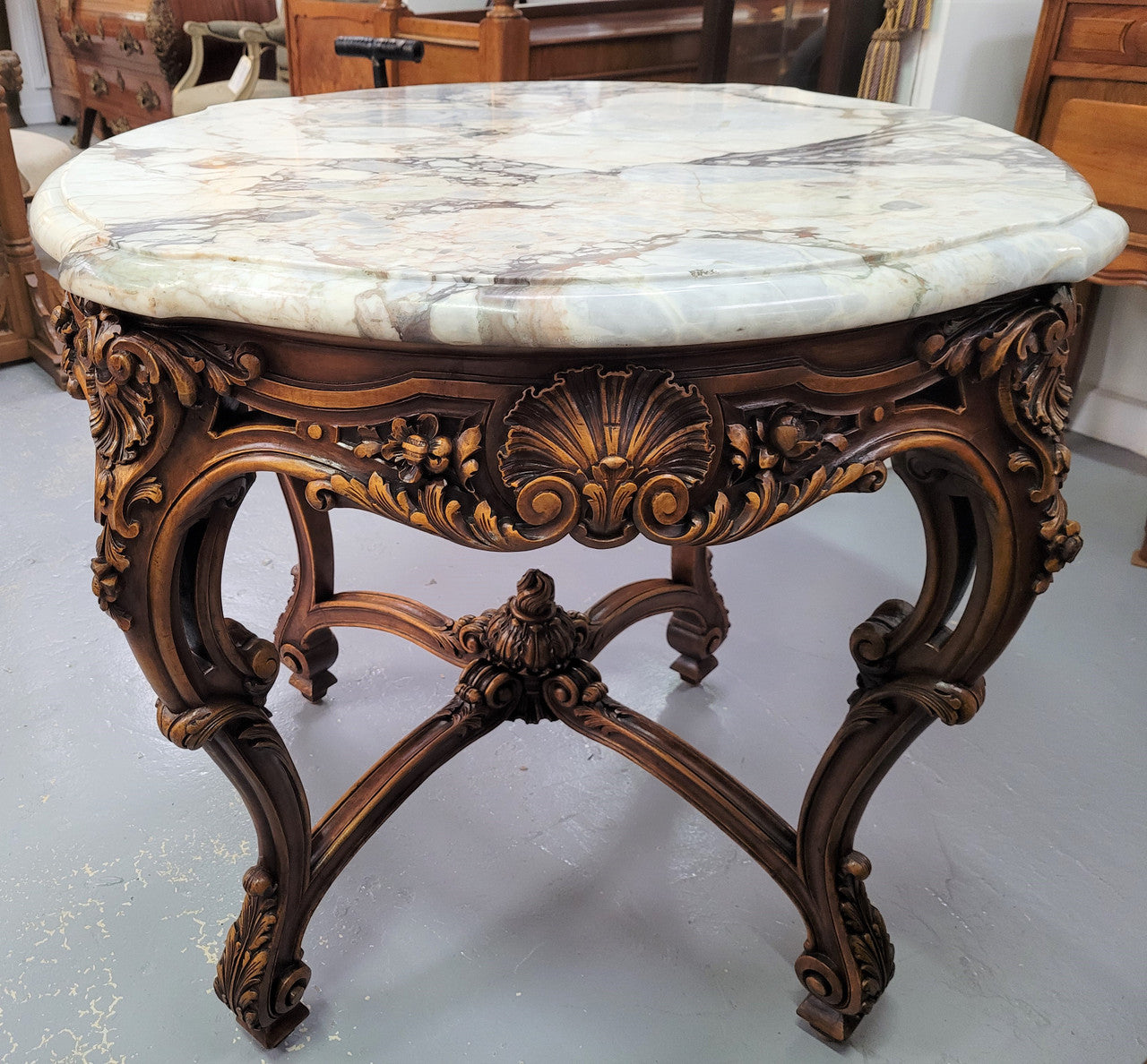 French Walnut Louis XV style round marble top centre table. It has amazing eye-catching marble, ornate detailed carvings and a beautifully carved undercarriage. In good original detailed condition.