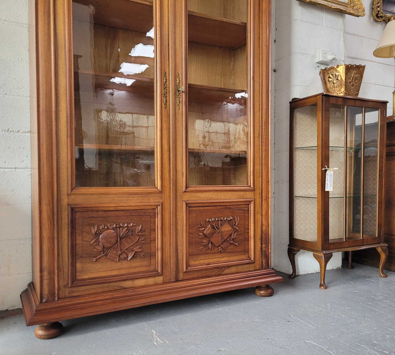 Stunning French Walnut Henry II style two door bookcase with four fully adjustable shelves. The lock on the door is functional and has a key. It is in good original detailed condition.