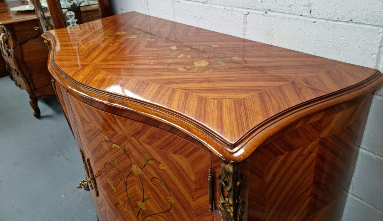 A high quality Louis XV style Kingwood marquetry inlay cabinet. Features extensive inlay inside the doors, and has beautiful ormolu mounts. In good original detailed condition.