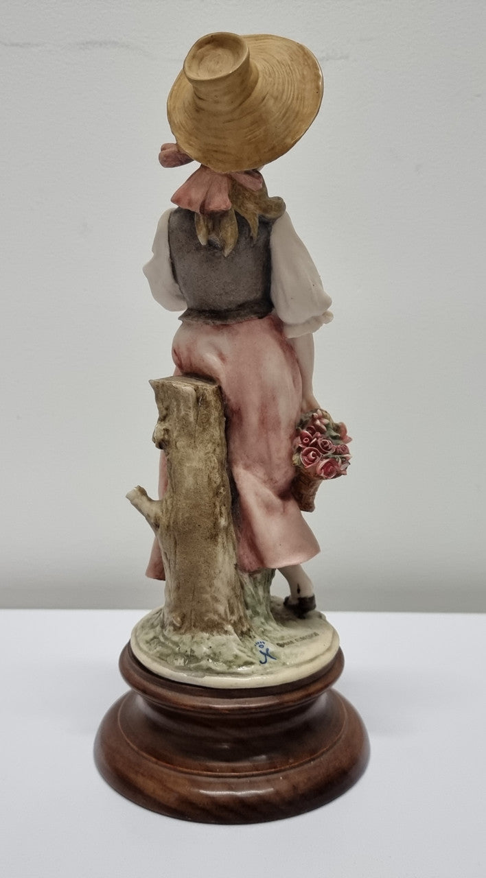 Lovely Italian figurine of girl carrying basket with flowers, figurine is on a wooden base. It is signed Giuseppe Armani and 1982 FLORENCE. In good original condition. Please view photos as they form part of the description.