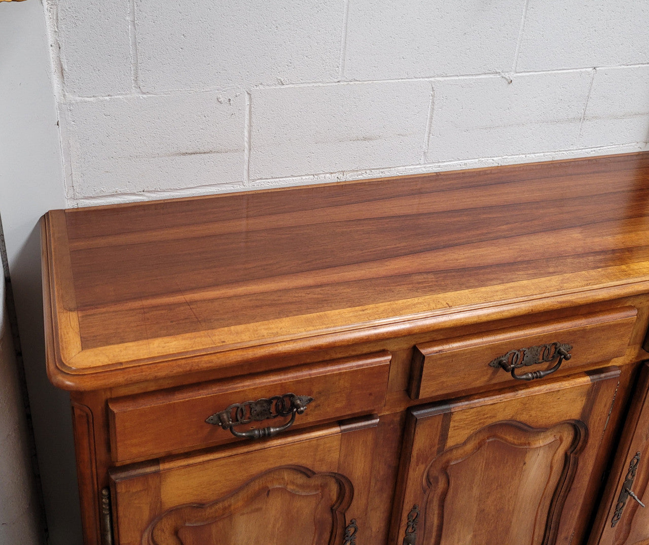 Beautiful French three door three drawer Louis XV style Cherrywood sideboard. It has a total of four adjustable shelves and comes with three keys. It has been sourced from France and is in good original detailed condition.