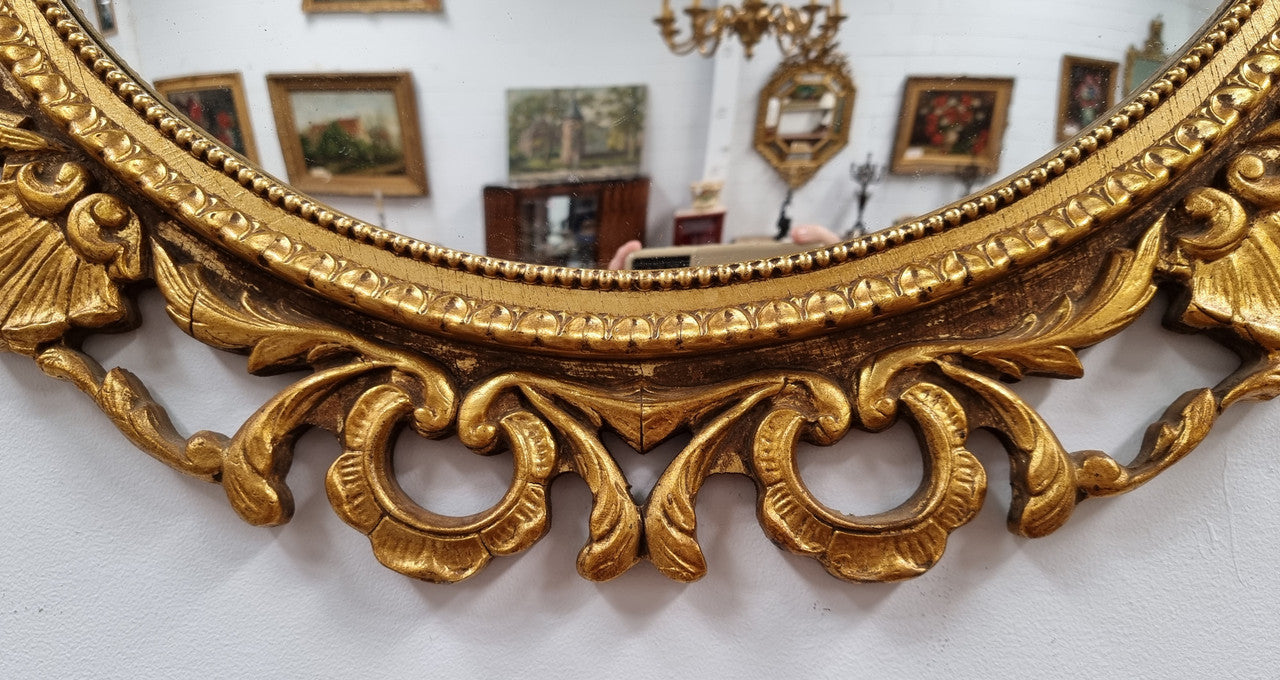 Vintage large round ornate convex mirror. Lovely gilt decoration around and is in good original condition.
