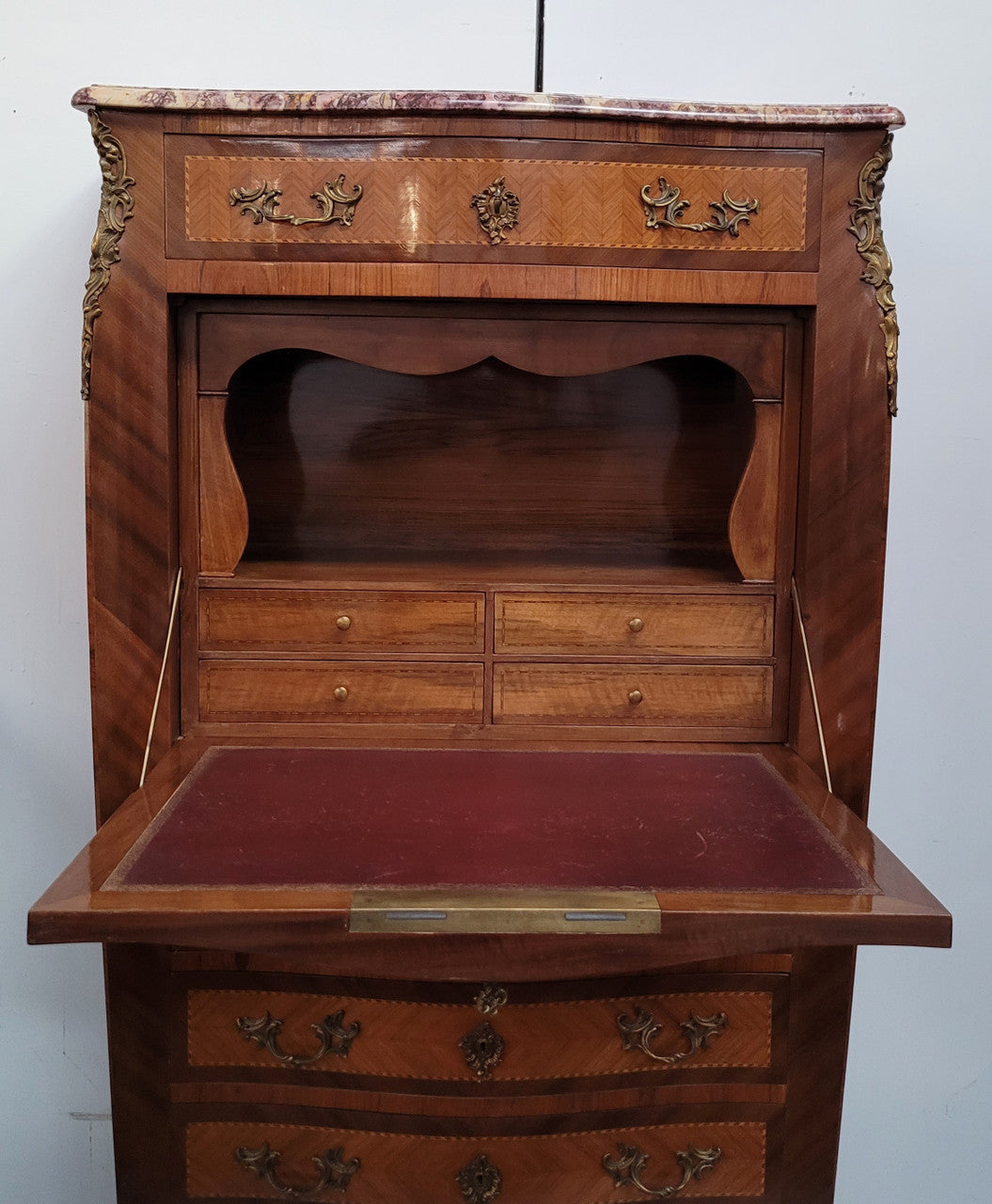 Walnut Louis XV style marble top abbattant with beautiful parquetry inlay and ormolu mounts. It has plenty of storage space with four large drawers and four smaller internal drawers. Beautiful drop down desk with a leather insert. In very good original detailed condition.
