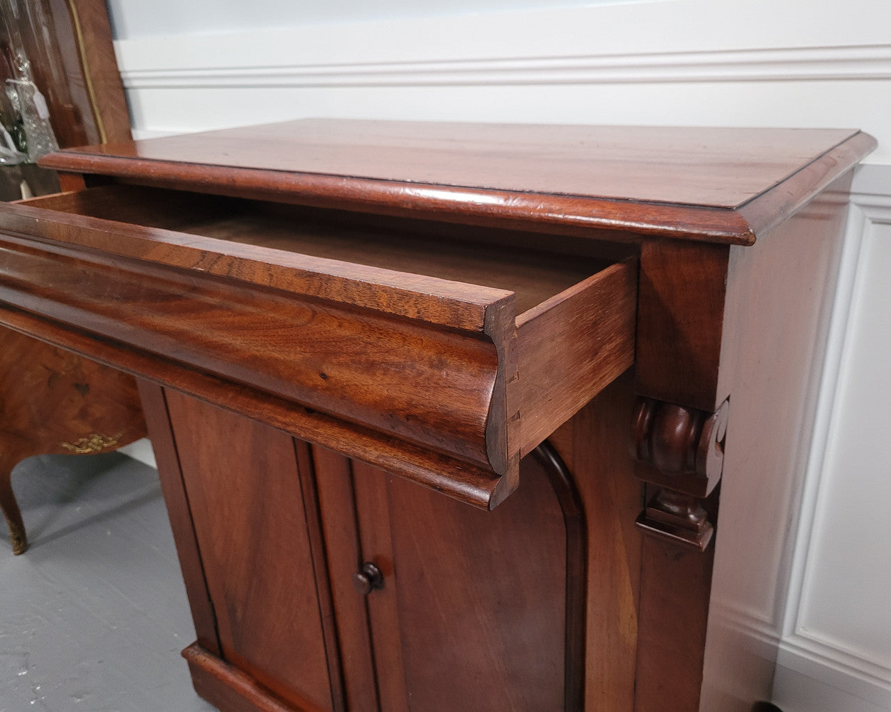 Cedar side cabinet with two doors one drawer and lovely door panels and corbels. It has been sourced locally and is in good original detailed condition.