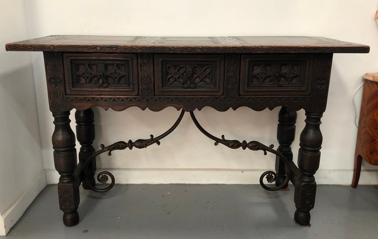 Spanish late 19th century carved oak three drawers console/side table. Superb wrought iron undercarriage. In good condition. Circa 1900's.