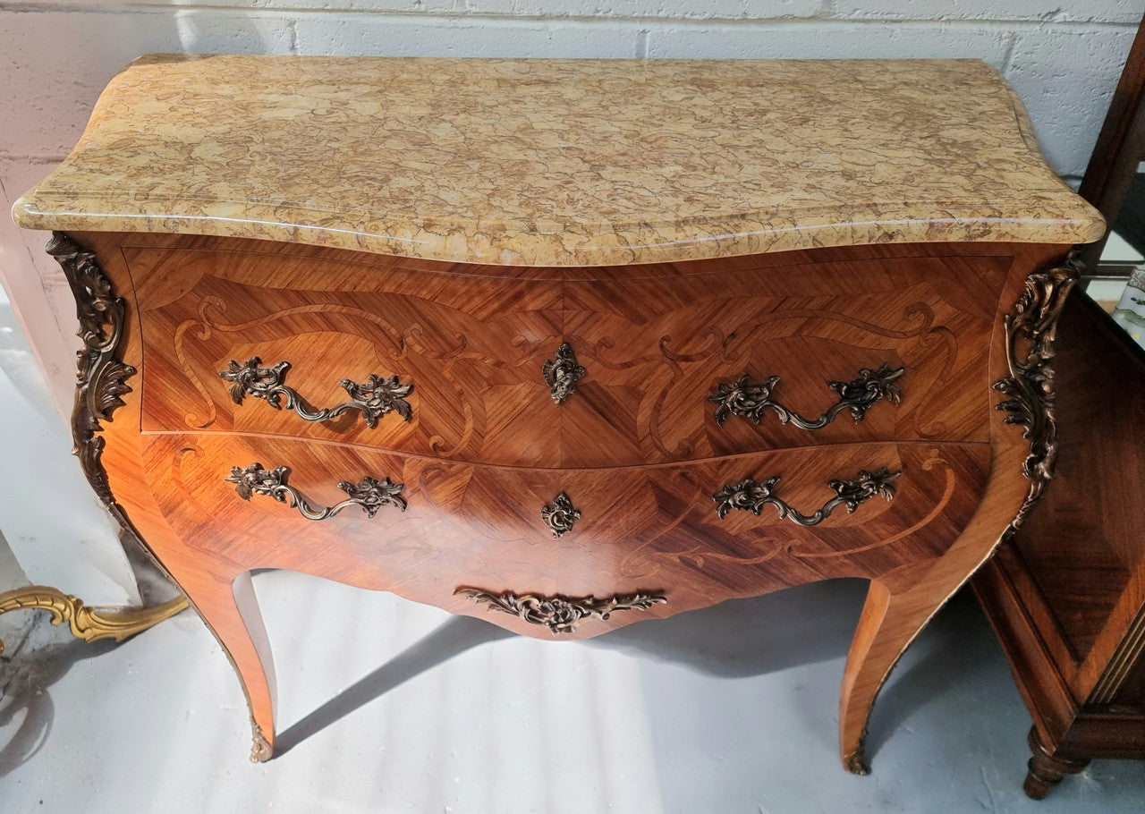 French marquetry inlaid Kingwood marble top commode. It has two drawers and beautiful mounts. Is in good original detailed condition.