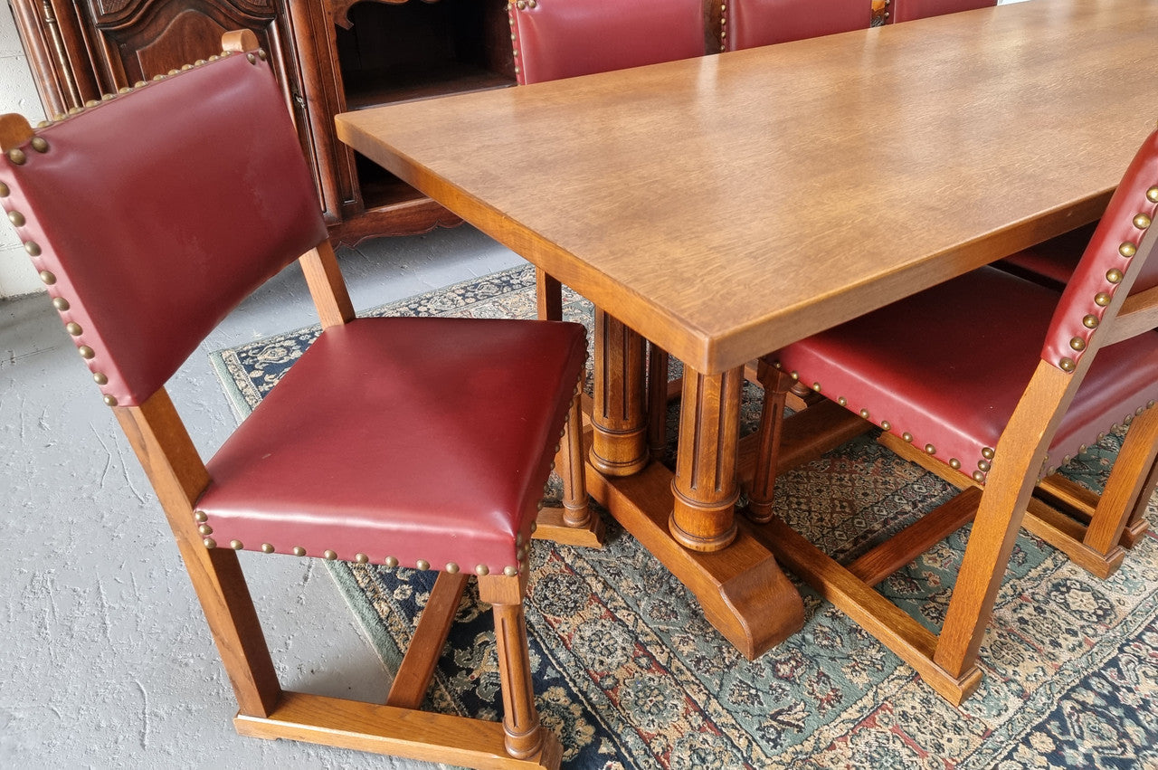 Set of eight Oak upholstered with faux leather dining chairs. They are in good original condition with only one chair having a slight tear in the upholstery as shown in photos.