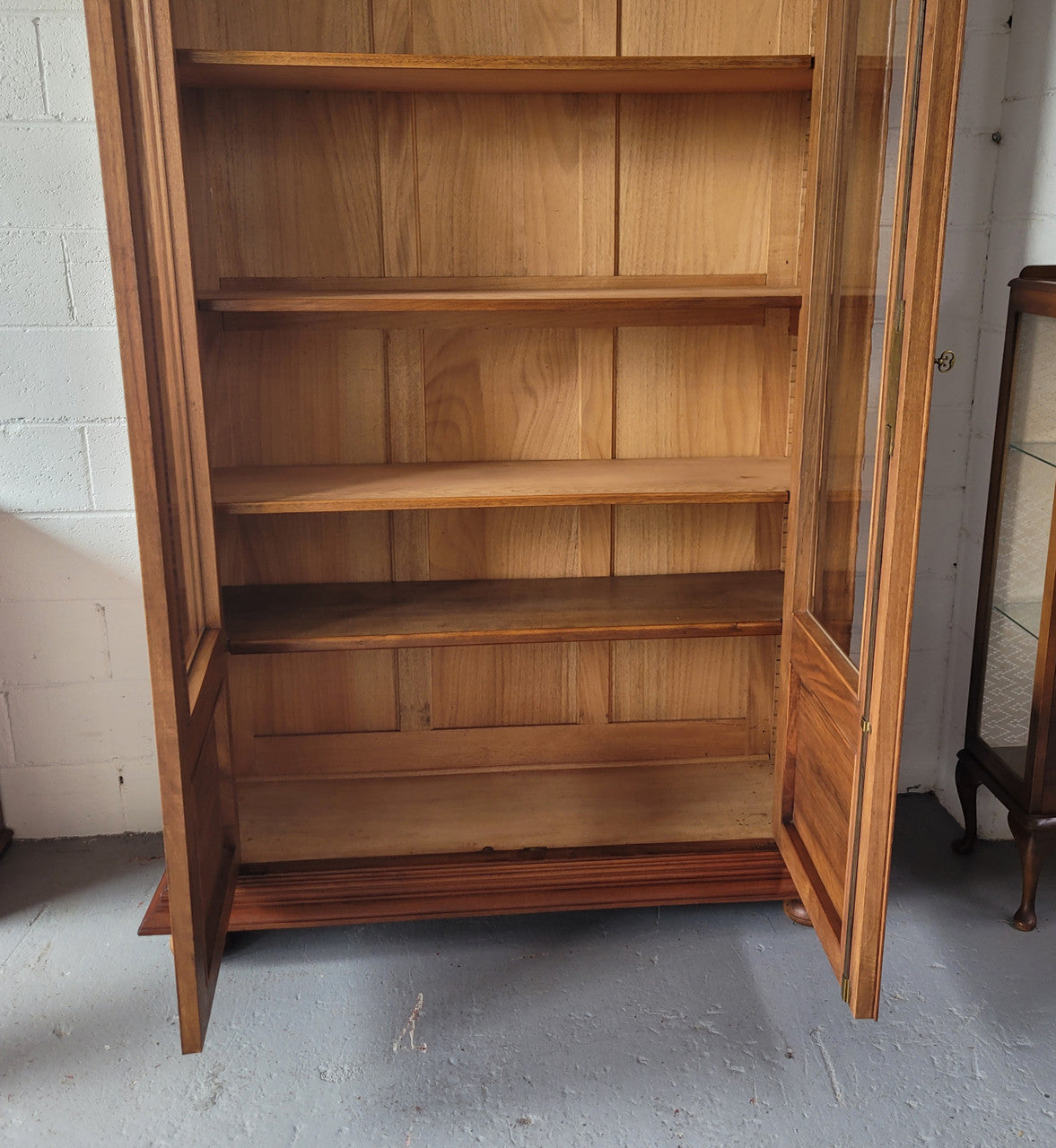 Stunning French Walnut Henry II style two door bookcase with four fully adjustable shelves. The lock on the door is functional and has a key. It is in good original detailed condition.