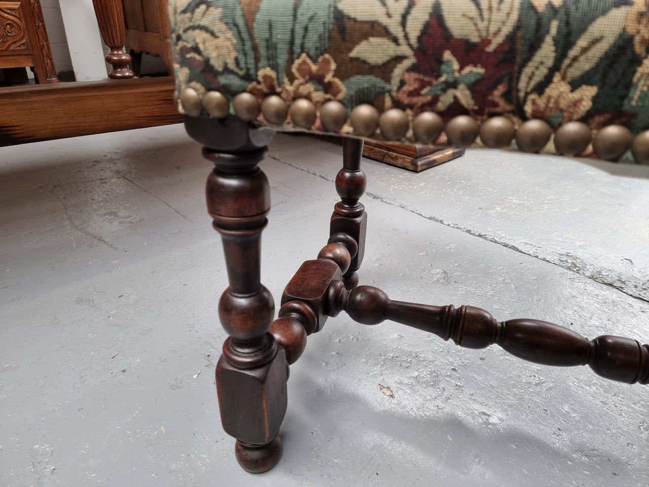 Flemish Baroque style Walnut footstool with tapestry fabric top. It is in good original detailed condition and has been sourced from France.