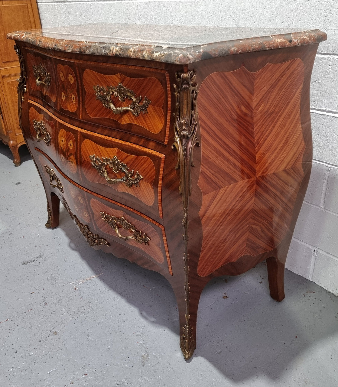 French Walnut and Kingwood Louis XV style marquetry inlaid commode with three drawers and a beautiful marble top. It is in good original detailed condition.