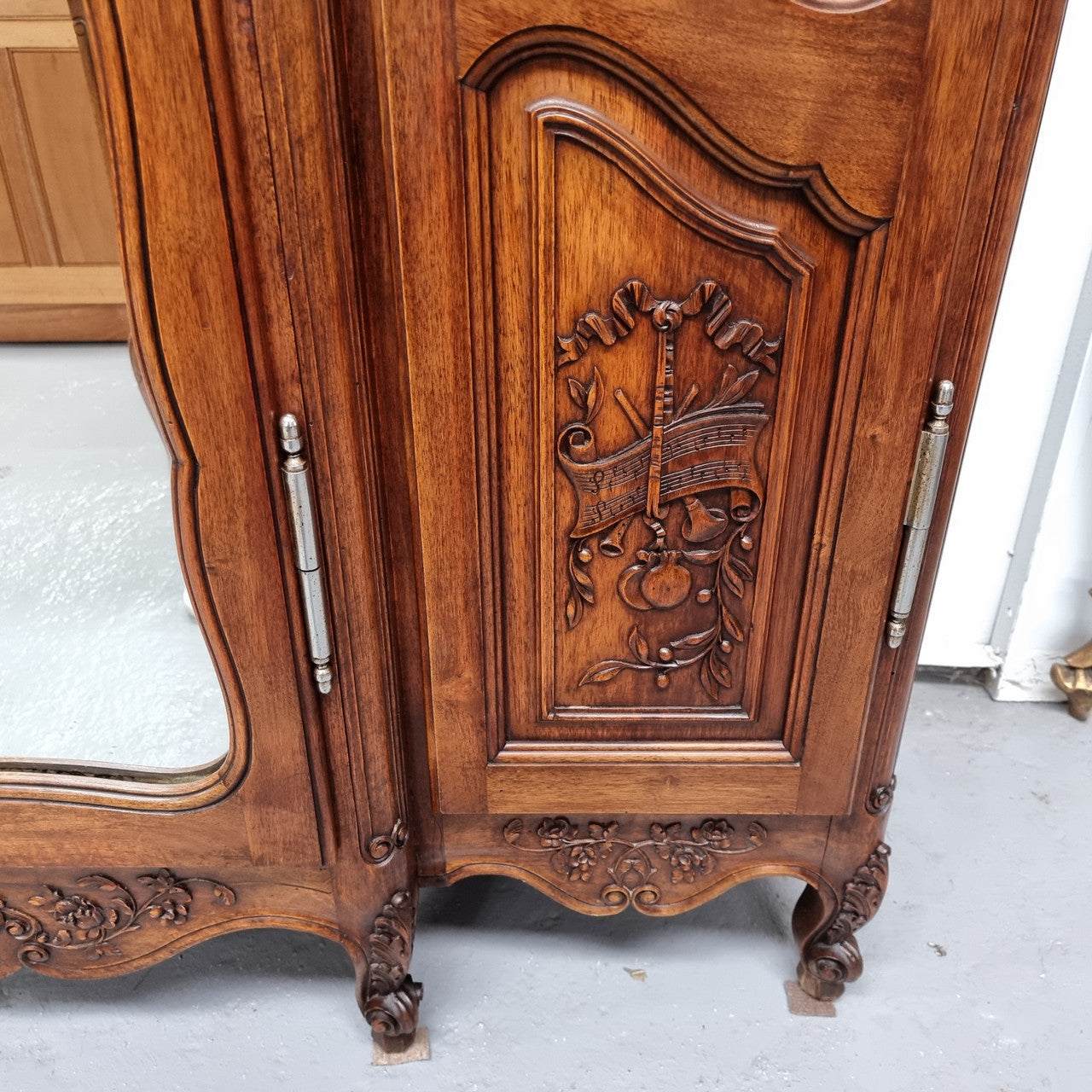 French Walnut Louis XV style three door armoire with 10 fully adjustable shelves in total spread over three sections, two drawers and a mirrored middle door. It has been sourced from France and in good original detailed condition.