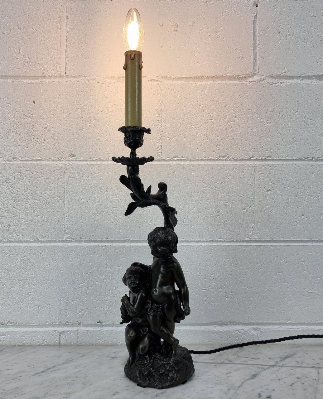 Antique French bronzed metal lamp with cherub's. in very good working original detailed condition.