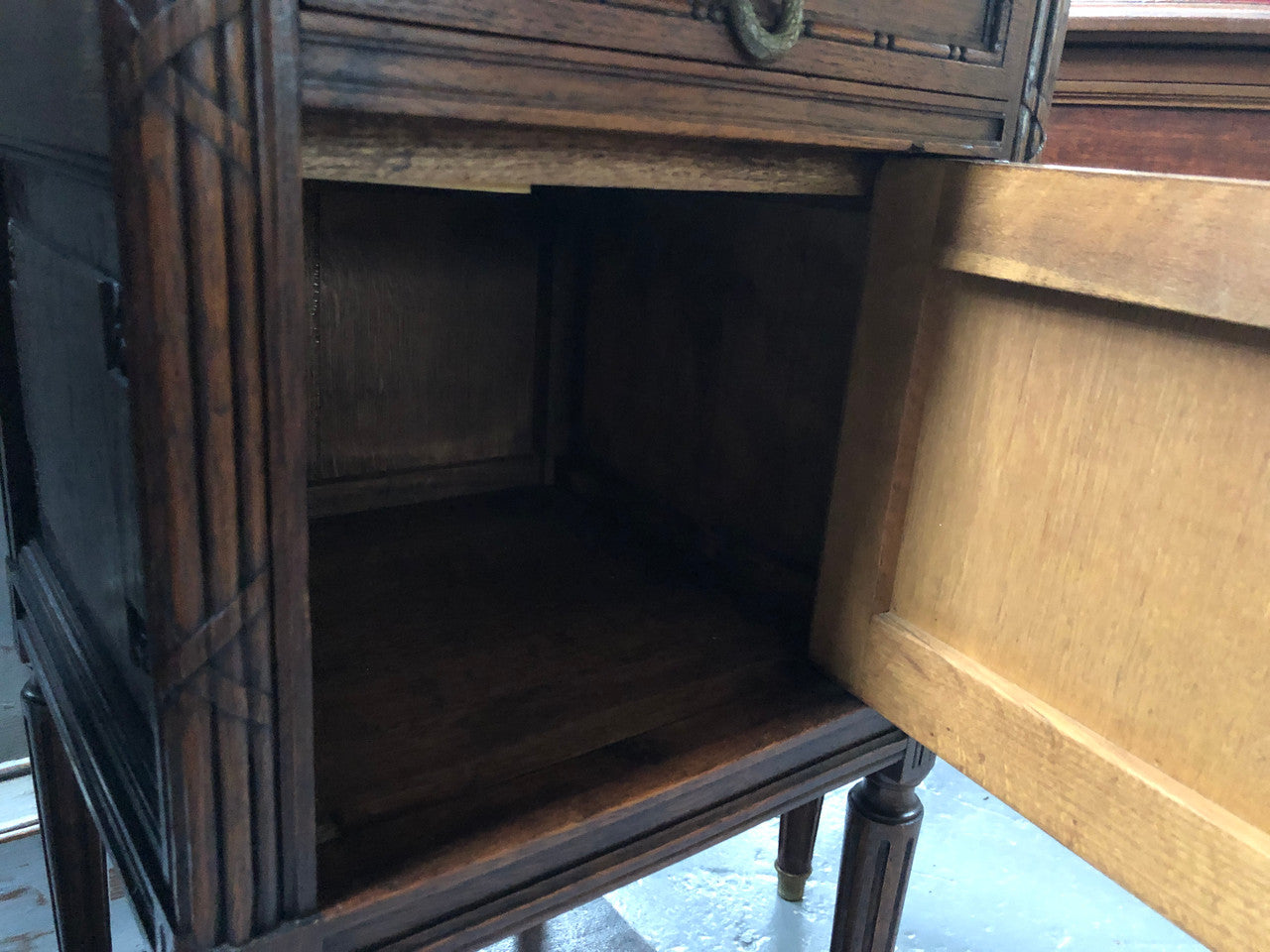 Lovely pair of French Oak Louis XVI style bedside cabinets with inset marble tops a drawer and a cupboard for storage. In good original detailed condition.