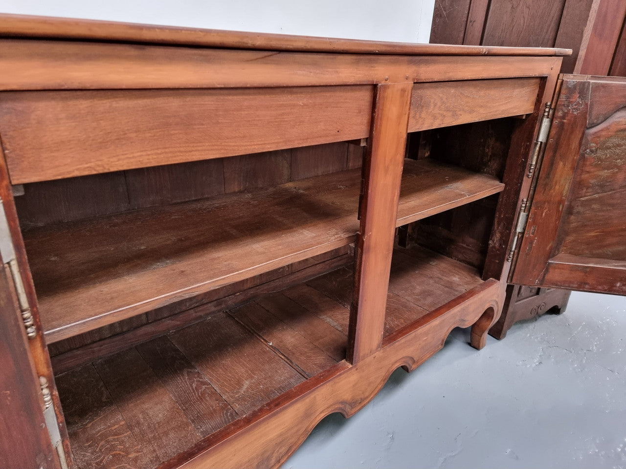 Early 19th Century Louis XV style Fruitwood three door sideboard. It has three hidden internal drawers and one of them has green valet and small sections for cutlery. It is in good restored condition.