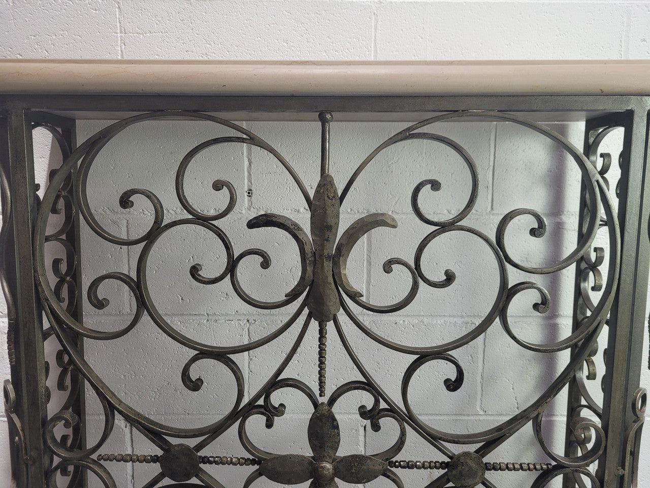 Stunning Art Deco wrought iron and marble top console table. It has amazing decorative iron work at the bottom and a beautiful marble top. It is in good original detailed condition.