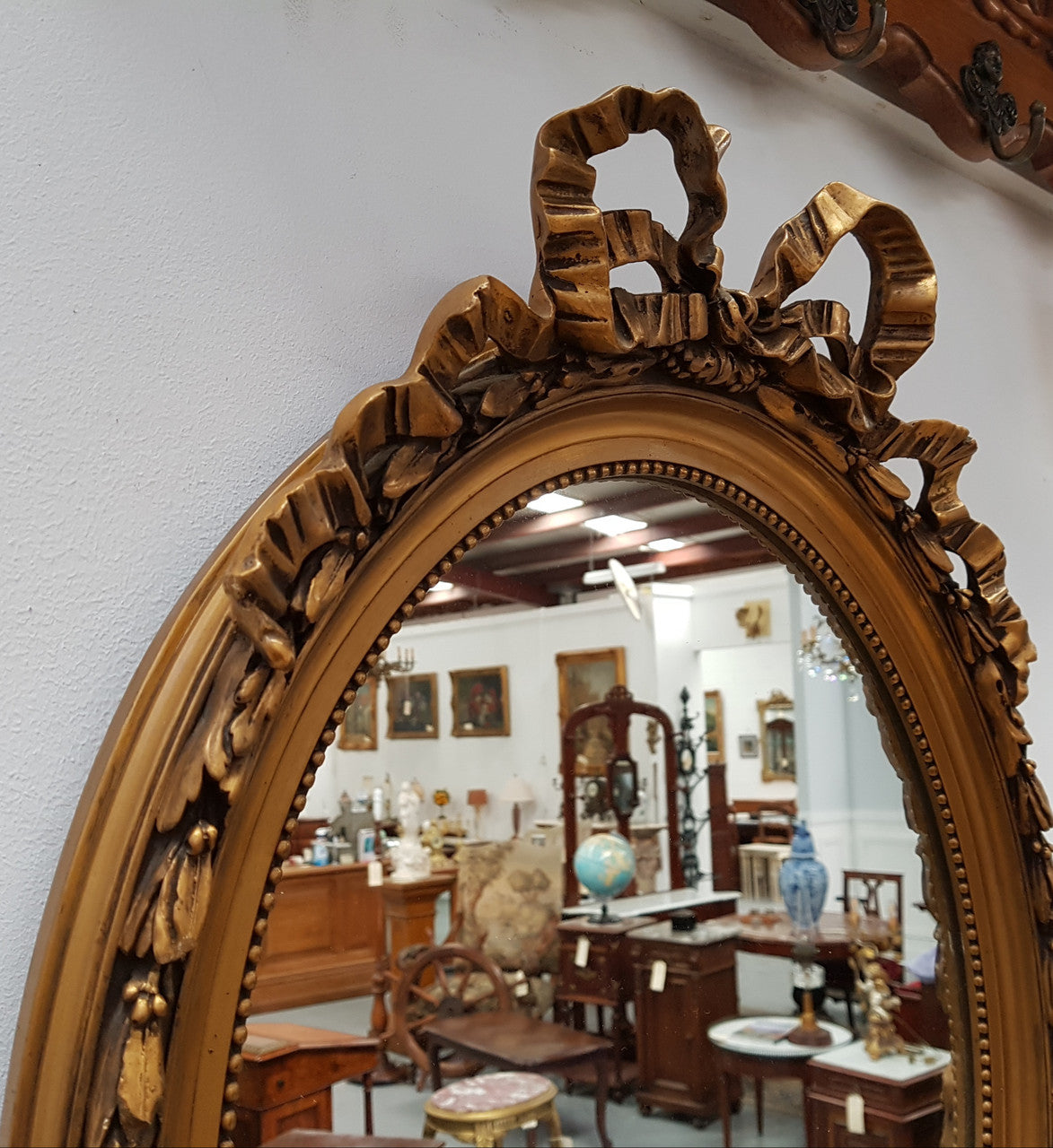 Antique French Gilt Oval Shape Mirror With Ribbon Crest