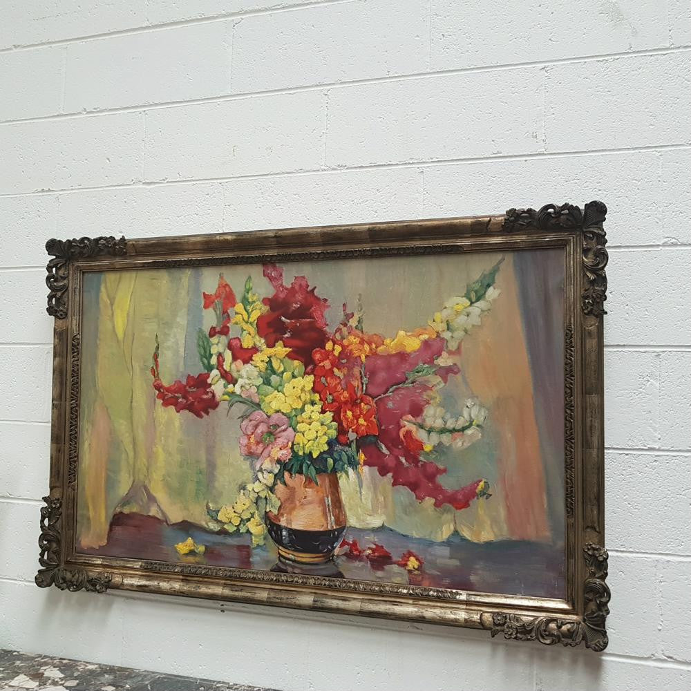 French floral oil on canvas painting, framed in a decorative frame and is in good original condition.