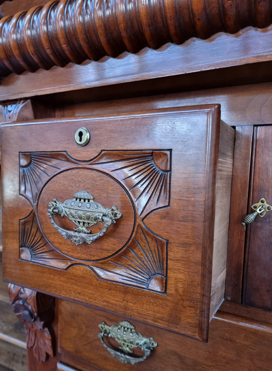 A 19th Century Scottish Mahogany tall boy/ chest of six drawers with small cabinet section at the top. Beautiful carvings and easily comes apart into three sections making transport for moving into place easy. In good original detailed condition.