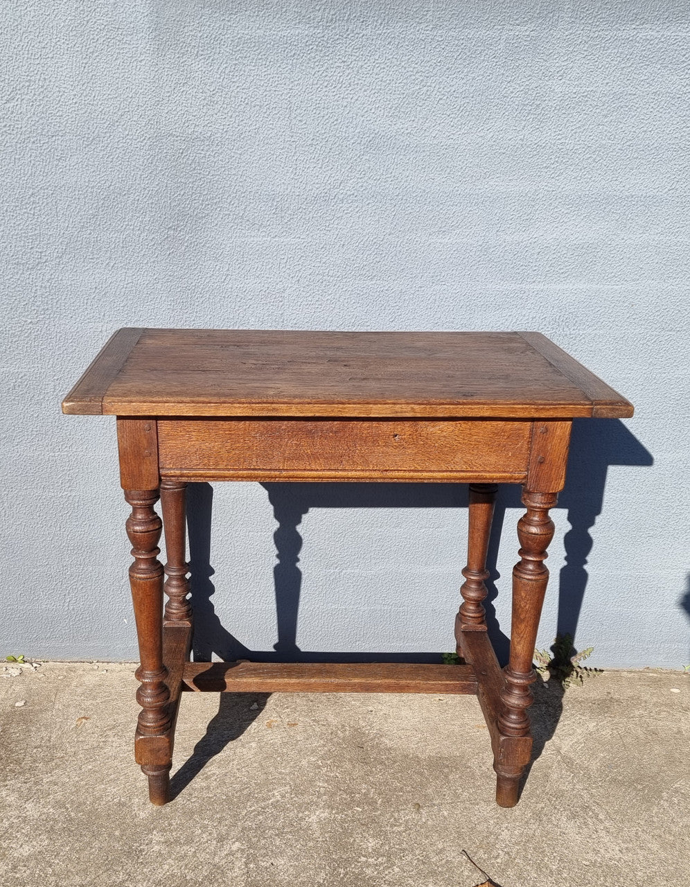 Lovely Oak Tudor style rope edge sideboard with leadlight centre door, three drawers and two solid cupboards. In good original condition.