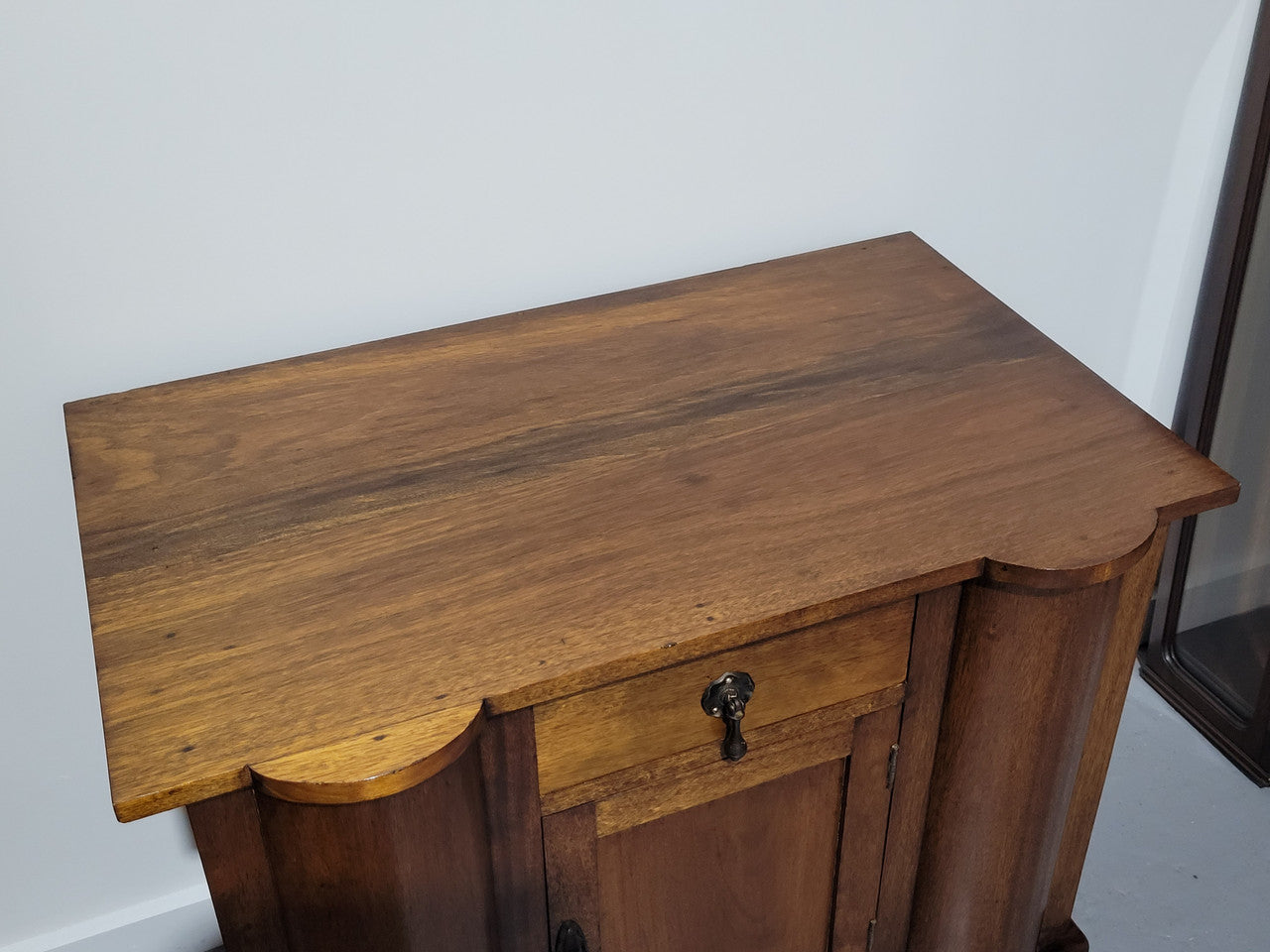 Queensland side cabinet of generous proportions. It has 1 drawer and one door with plenty storage space. In good original detailed condition.