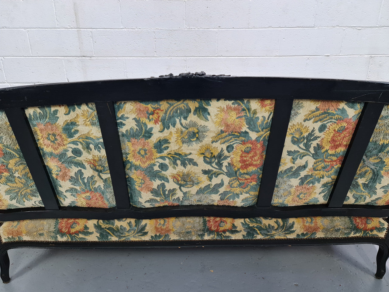 A Substantial Antique 19th Century Louis XV style ebonized serpentine front settee. The fabric is in used condition showing use and could be used as is or reupholster.
