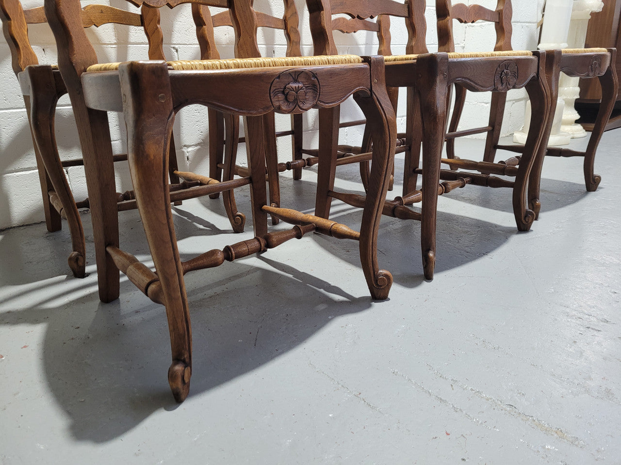A stunning set of six French Louis XV Style oak dining chairs with rush seats in good original condition. All chairs have been detailed and re-glued where needed.
