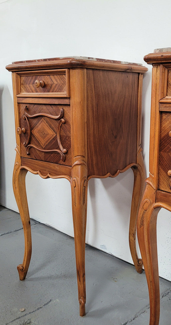 Pair French Walnut Louis XV style Bedside Cabinets with inset rouge carrera marble tops and parquetry inlay. Consisting of one drawer and one cupboard on very elegant legs. Circa: 1900's.