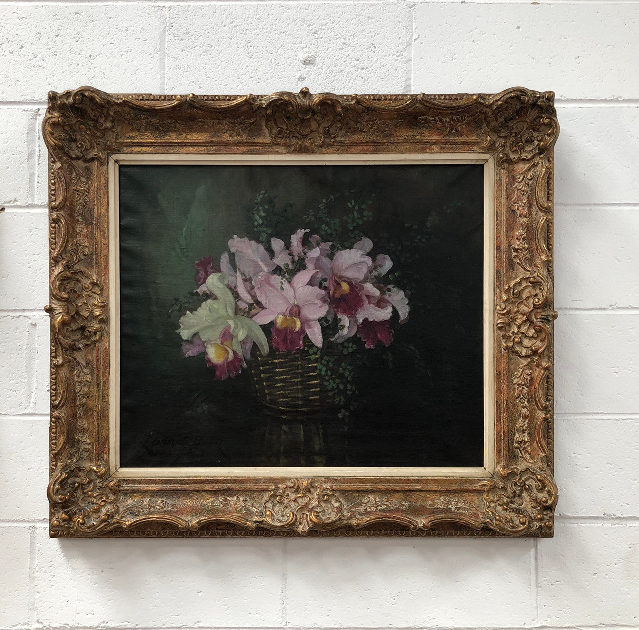 Signed French oil on canvas painting of "Orchids In Basket" In a beautiful ornate gilt frame. In good original detailed condition.