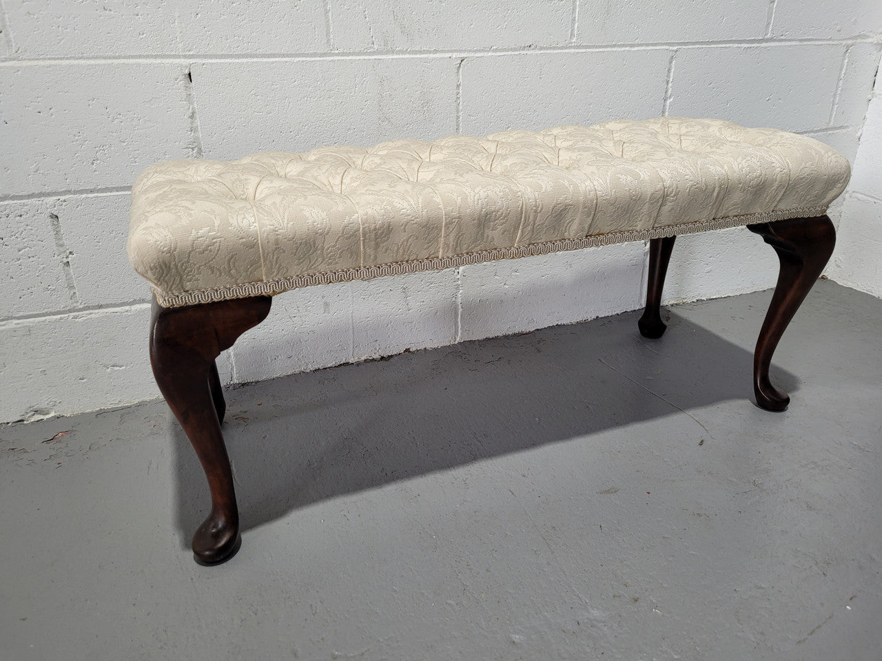 Vintage neutral upholstered buttoned stool. Fabric is in good used condition, please view photo's has they help form the description. The stool its self is in good condition.