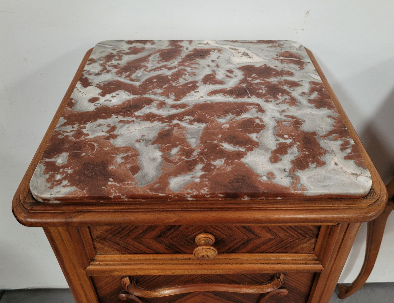 Pair French Walnut Louis XV style Bedside Cabinets with inset rouge carrera marble tops and parquetry inlay. Consisting of one drawer and one cupboard on very elegant legs. Circa: 1900's.