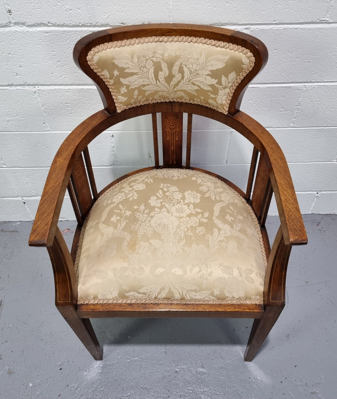 Charming Edwardian inlaid walnut upholstered armchair. In good original condition.