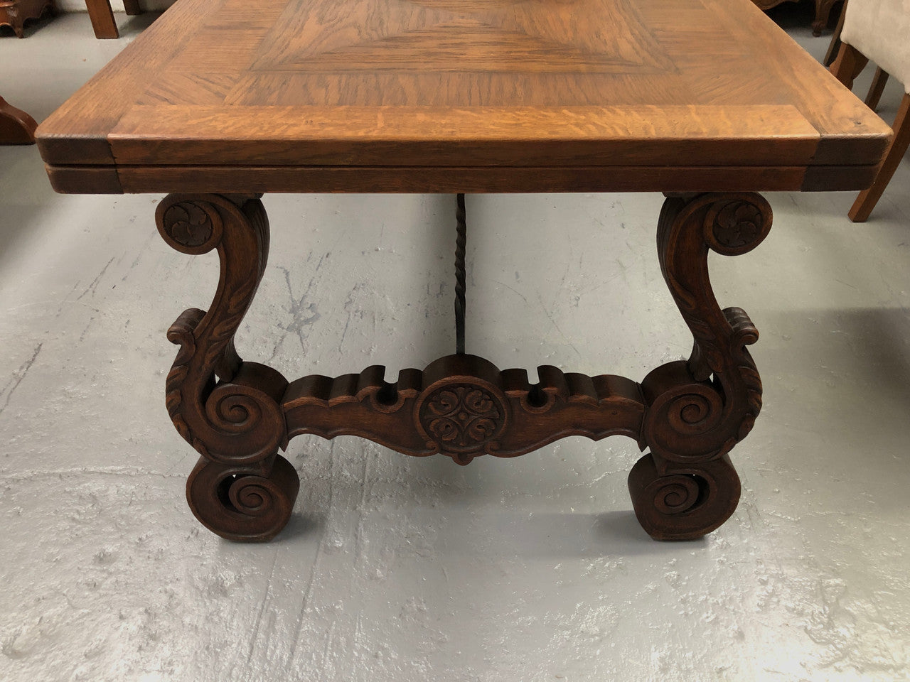 French Oak Renaissance style extension table with a lovely parquetry top and decorative carved and iron base in good original detailed condition.