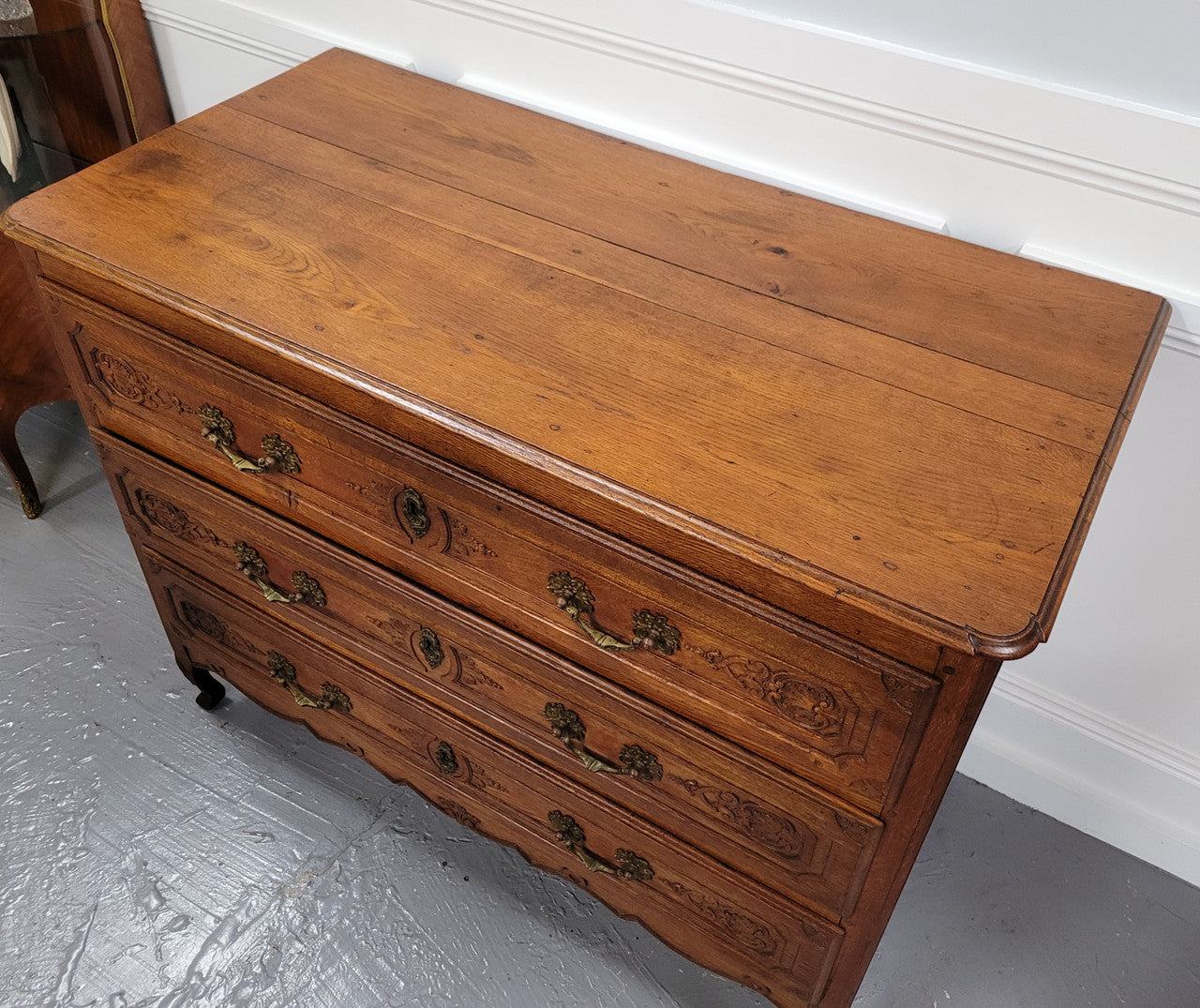 French Louis 15th style large three drawer chest featuring carved drawers. It has been sourced from France and is in good original detailed condition.