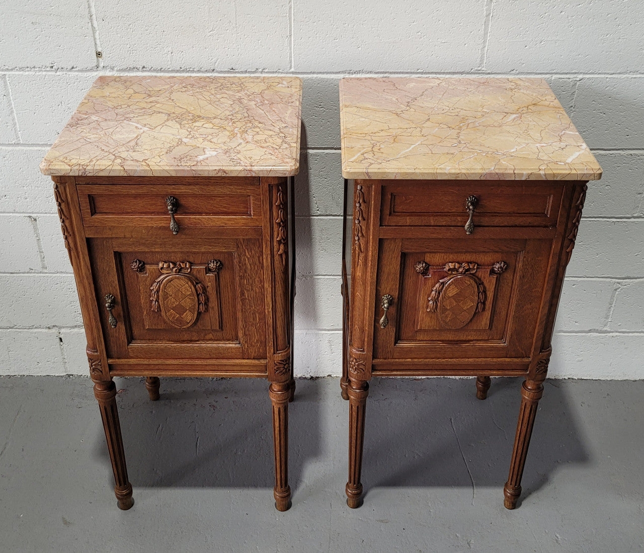 Pair of Louis XV French Oak and marble top bedside cabinets. They have beautiful detailed carving and stunning colour marble top. They are in very good original detailed condition.