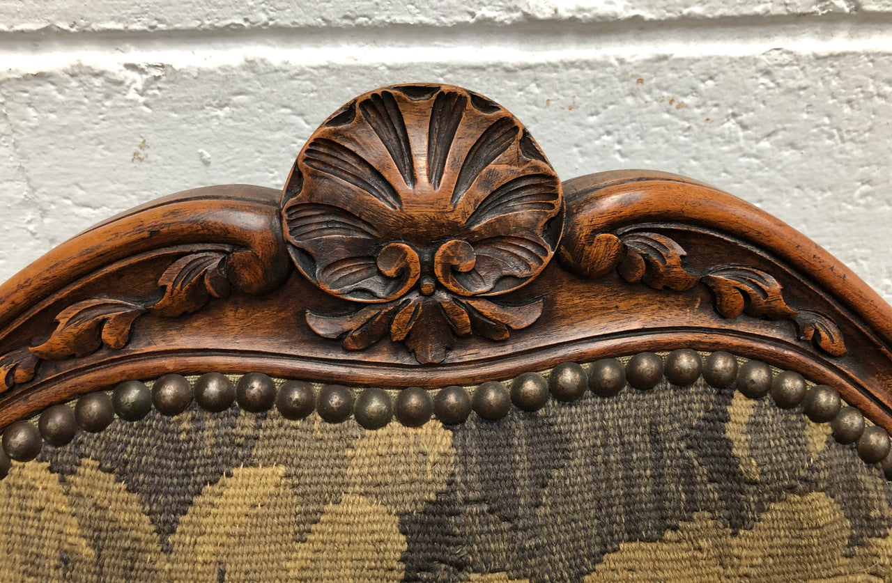Pair of 19th Century French walnut tapestry covered arm chairs. They are in good original condition. Circa 1890.