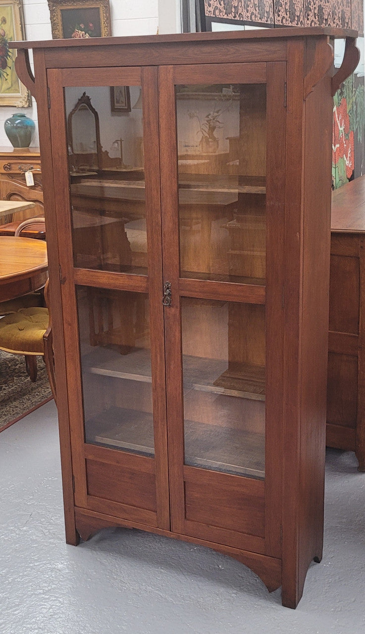 Beautiful two door Blackwood bookcase with glass doors and with four fully adjustable shelves. It is in good original detailed condition.