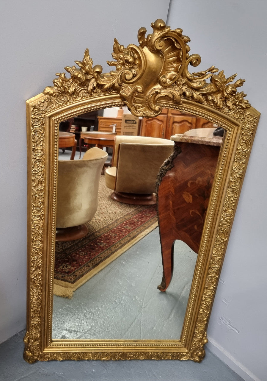 Late 19th Century French Louis XV style carved gilt wall mirror. Sourced from France and in good original detailed condition.