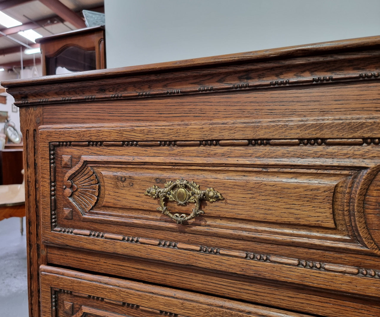 Early 19th Century French Oak chest of three drawers. It has beautiful handles and carvings. It is in good original detailed condition.