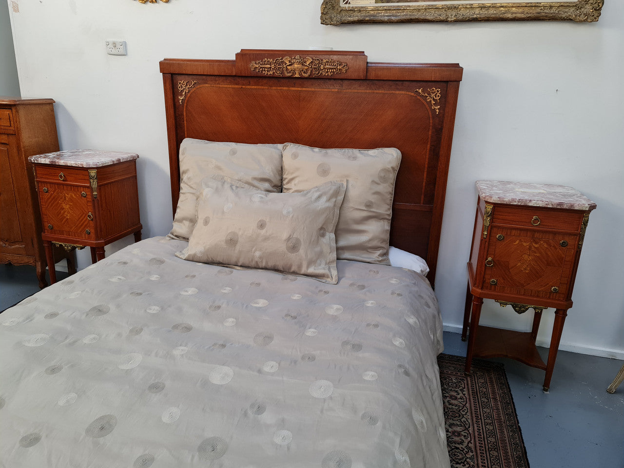 A high quality French Louis XV style bow fronted Queen size bed with marquetry inlay and ormolu mounts. In good original detailed condition. Circa: 1920