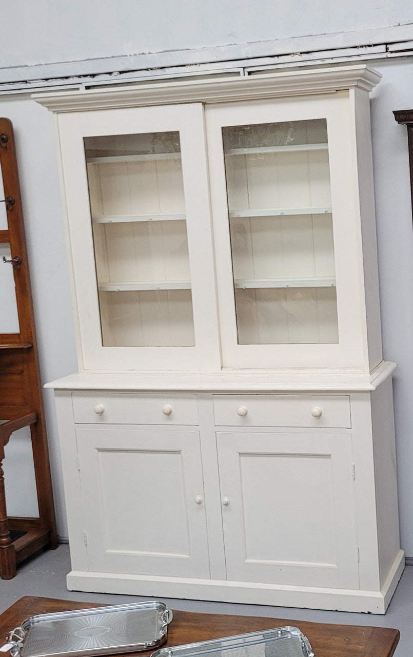 Australian painted two door kitchen hutch display and buffet cabinet. The top section has hooks and shelves. The bottom has two drawers along with cupboard space for added storage. In good original condition.