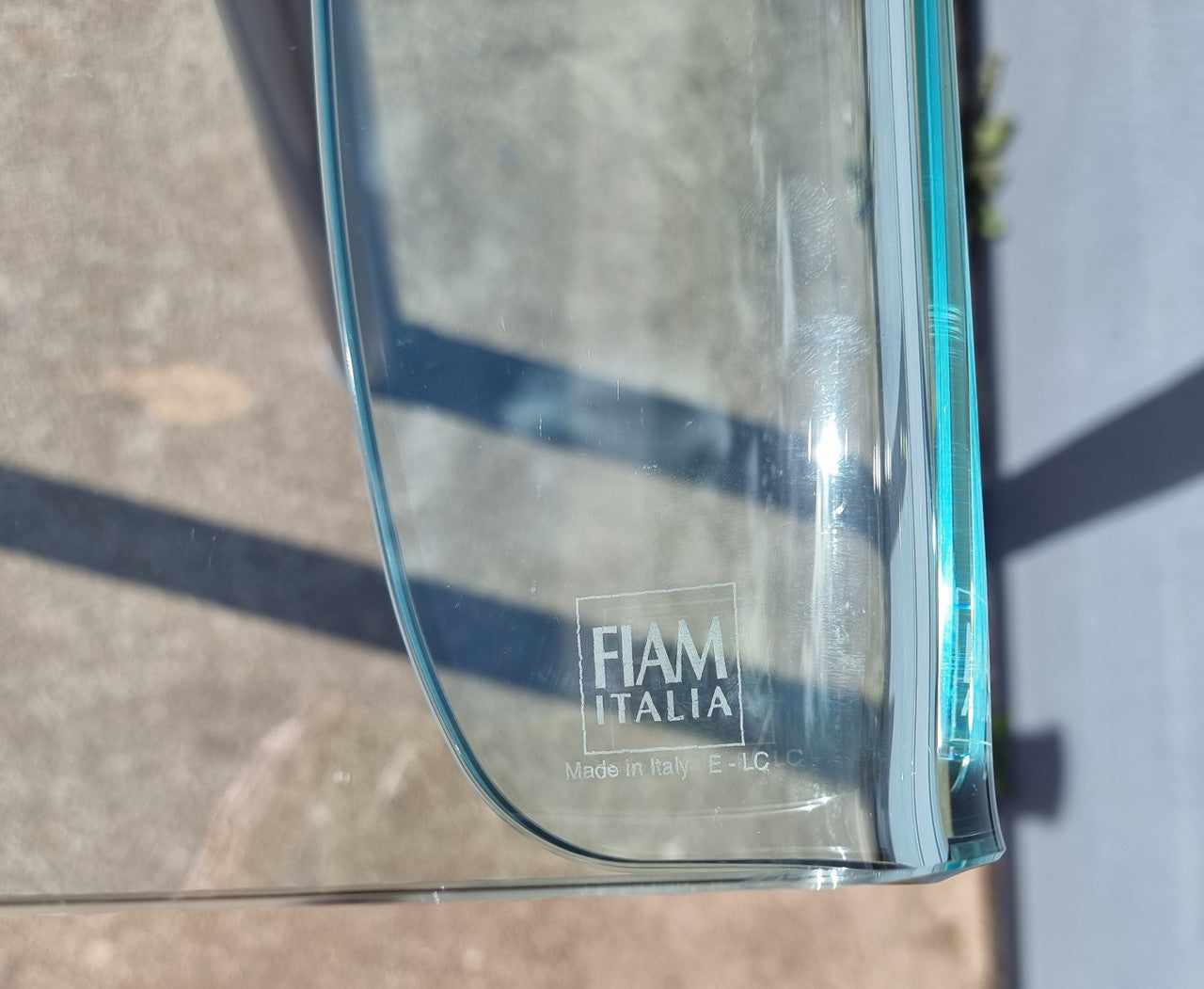 Striking and distinctive Vintage FIAM Italia Designer curved edge glass desk. FIAM was founded in 1973 by Vittorio Livio and has become synonymous with glass culture in Italy and the World. FIAM is still manufacturing today, in collaboration with various Designers, and has won numerous awards and is represented in various international museums. 
Condition: Evidence of use with minor scratches to the surface and a small chip that has been repaired. Overall, in very good condition with one repaired chip to t