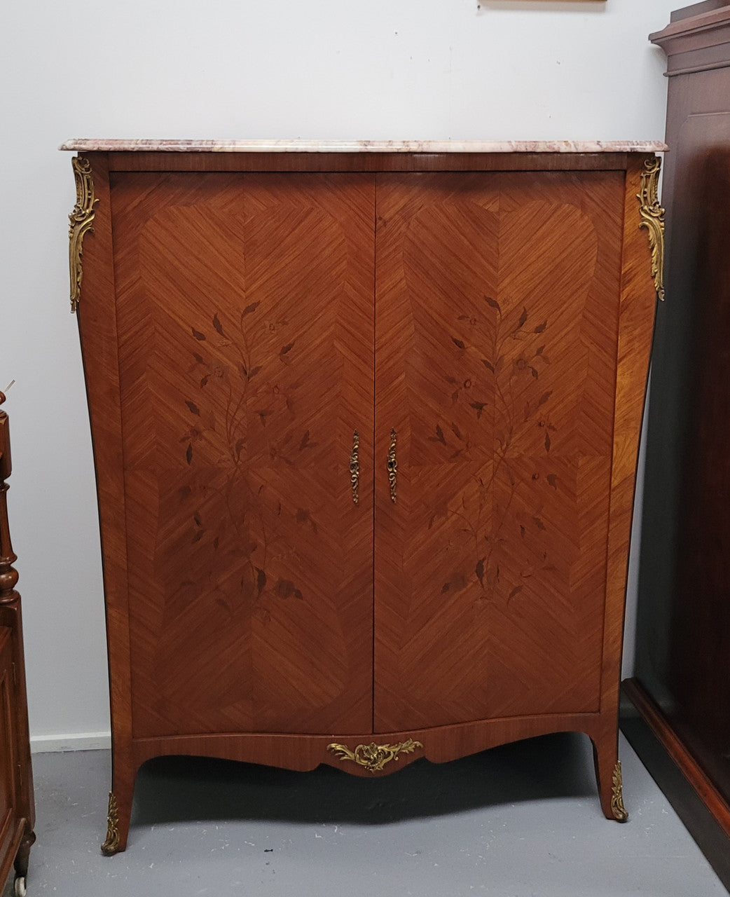 French Louis 15th style Kingwood marquetry inlaid two door cupboard with a beautiful marble top. It has three adjustable shelves and decorative ormolu trim. It has been sourced from France and is in good original detailed condition.