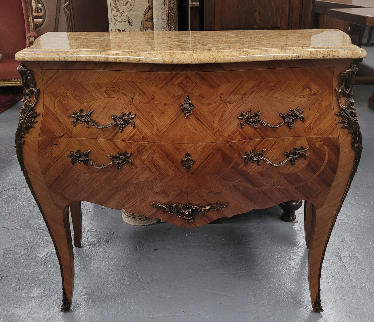 An elegant French Louis XV style kingwood two drawer commode with beautiful decorative inlay and ormolu mounts. Stunning coloured marble top and is in good original detailed condition.