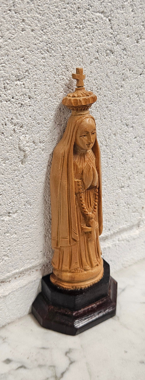 Vintage Olivewood statue of praying Virgin Mary on dark wooden plinth. Condition comensurate with age, please view photos as they help form part of the description.