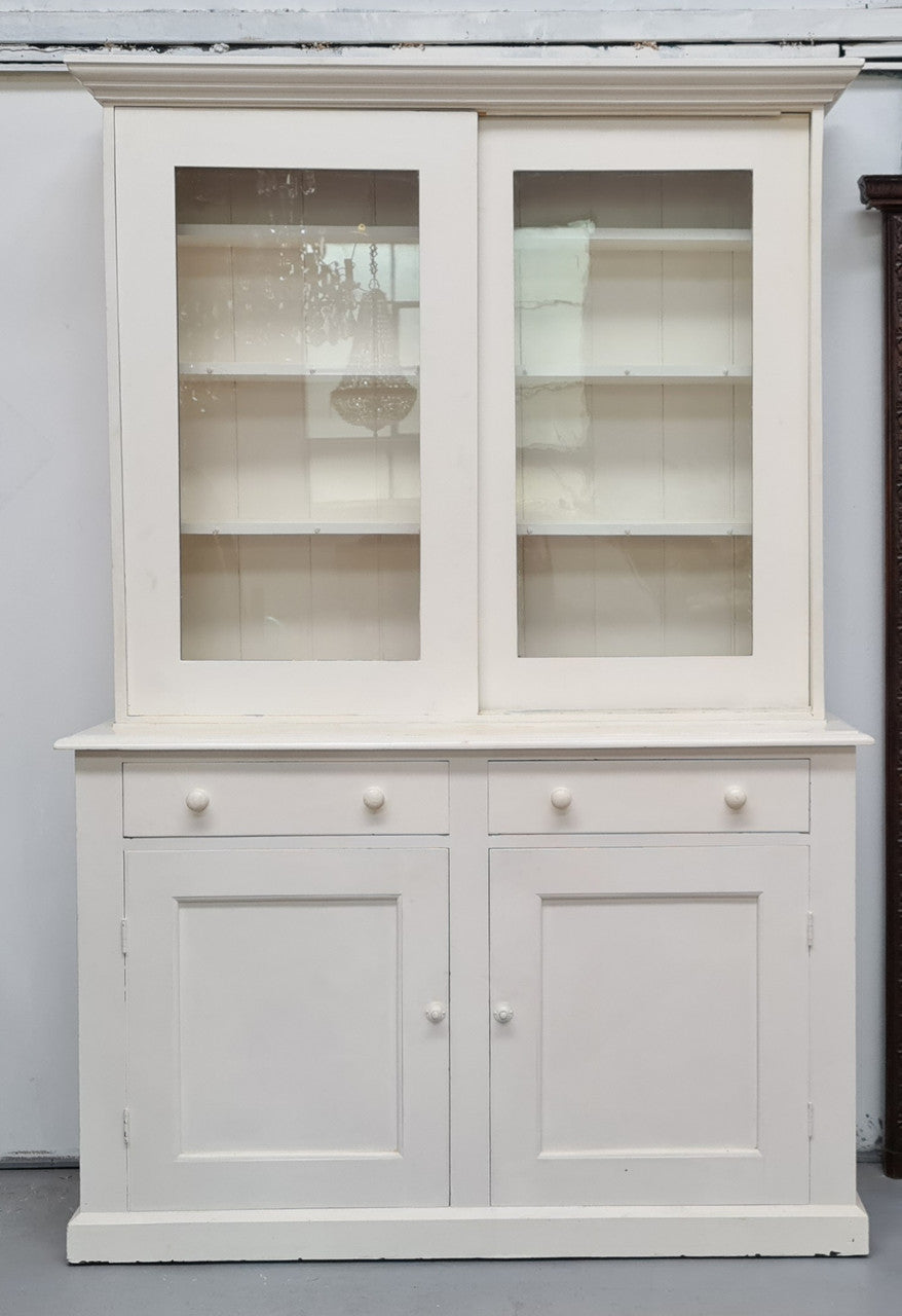 Australian painted two door kitchen hutch display and buffet cabinet. The top section has hooks and shelves. The bottom has two drawers along with cupboard space for added storage. In good original condition.