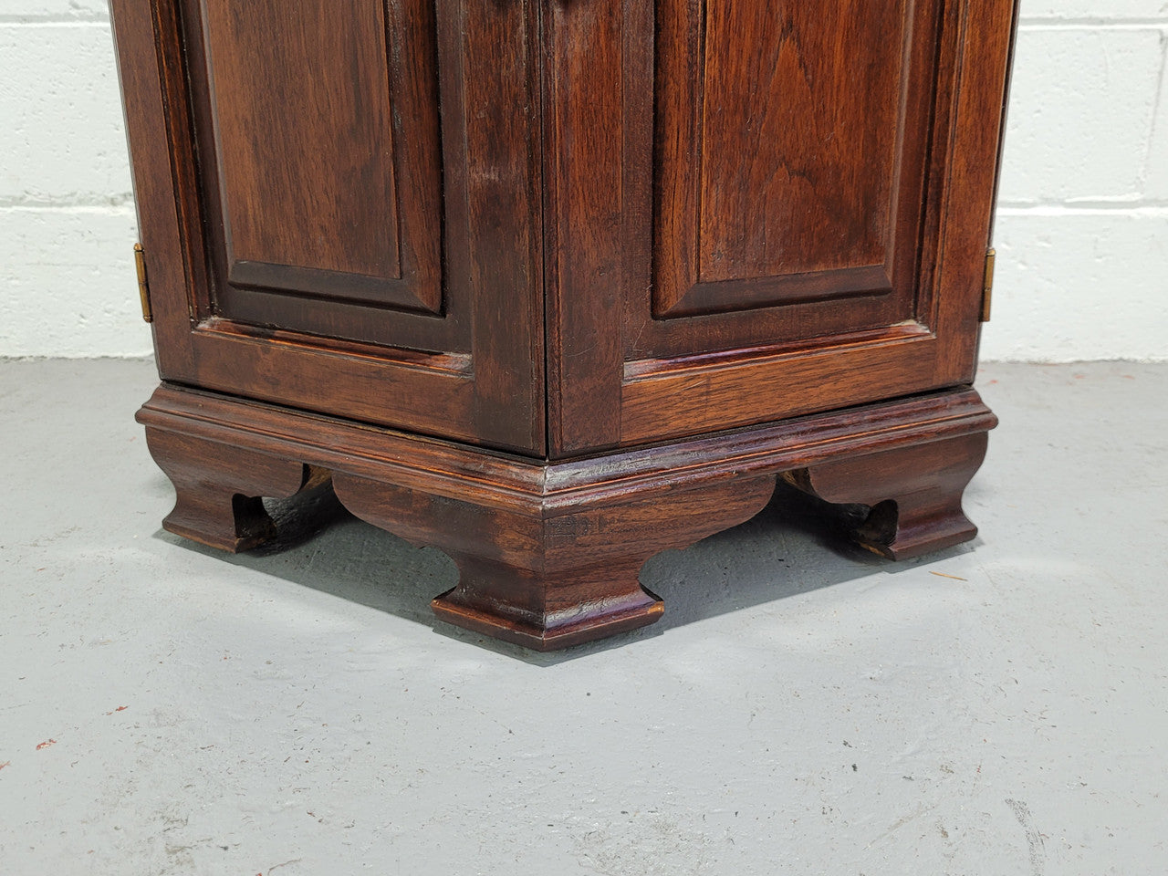 Hexagonal Mahogany enclosed side cabinet with two doors. Would make an ideal side cabinet and is in good restored condition.